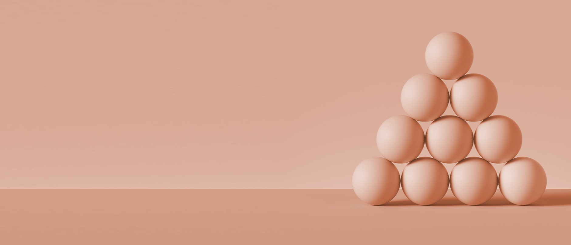 10 peach spheres arranged in a pyramid with peach background