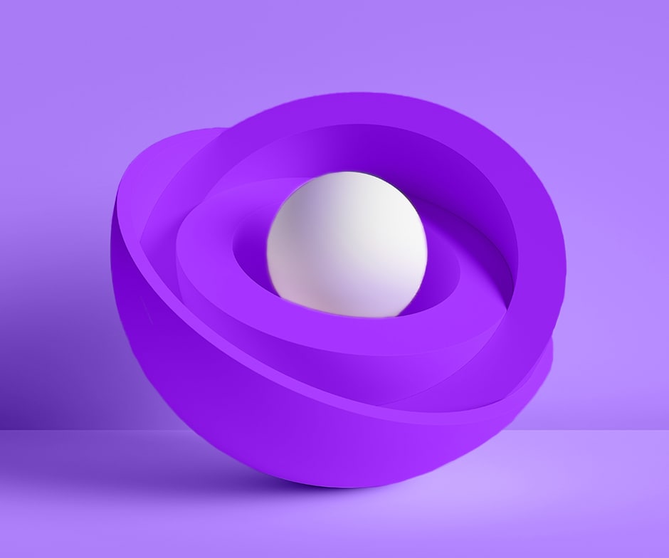 purple background behind purple nested bowls with white sphere in the middle